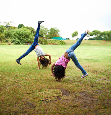 Buy stock photo Happy woman, children and friends in cartwheel on green grass or field together for fun day at the park. Young girls, teens or kids playing and handstands for freedom, activity or games in nature