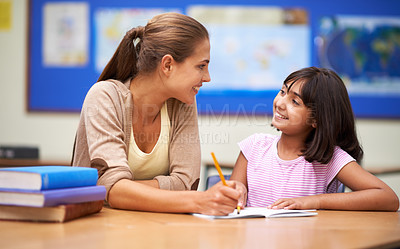 Buy stock photo School, education or learning with a girl student and teacher in a classroom together for writing or child development. Study, scholarship and teaching with a woman educator helping a child in class
