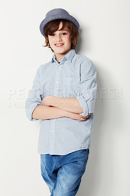 Buy stock photo Boy, confidence and portrait for fashion in studio, cool clothing and arms crossed by white background. Happy male person, child and cool hat by backdrop or pride for style, face and trendy outfit