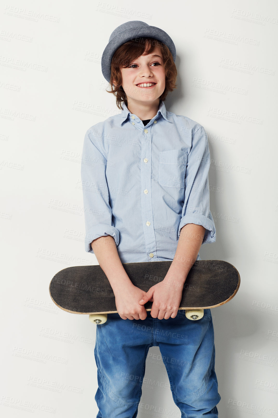 Buy stock photo Child, boy and skateboard for fashion in studio, cool clothing and confidence by white background. Happy male person, kid and hat by backdrop or pride for activity, smile and trendy outfit or sports