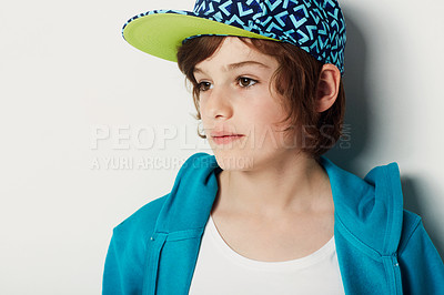 Buy stock photo Thinking, fashion and young child in a hoodie in studio isolated on a white background. Trendy style, cool kid and cap of boy or model in a hat, casual clothes and serious on a backdrop in Sweden