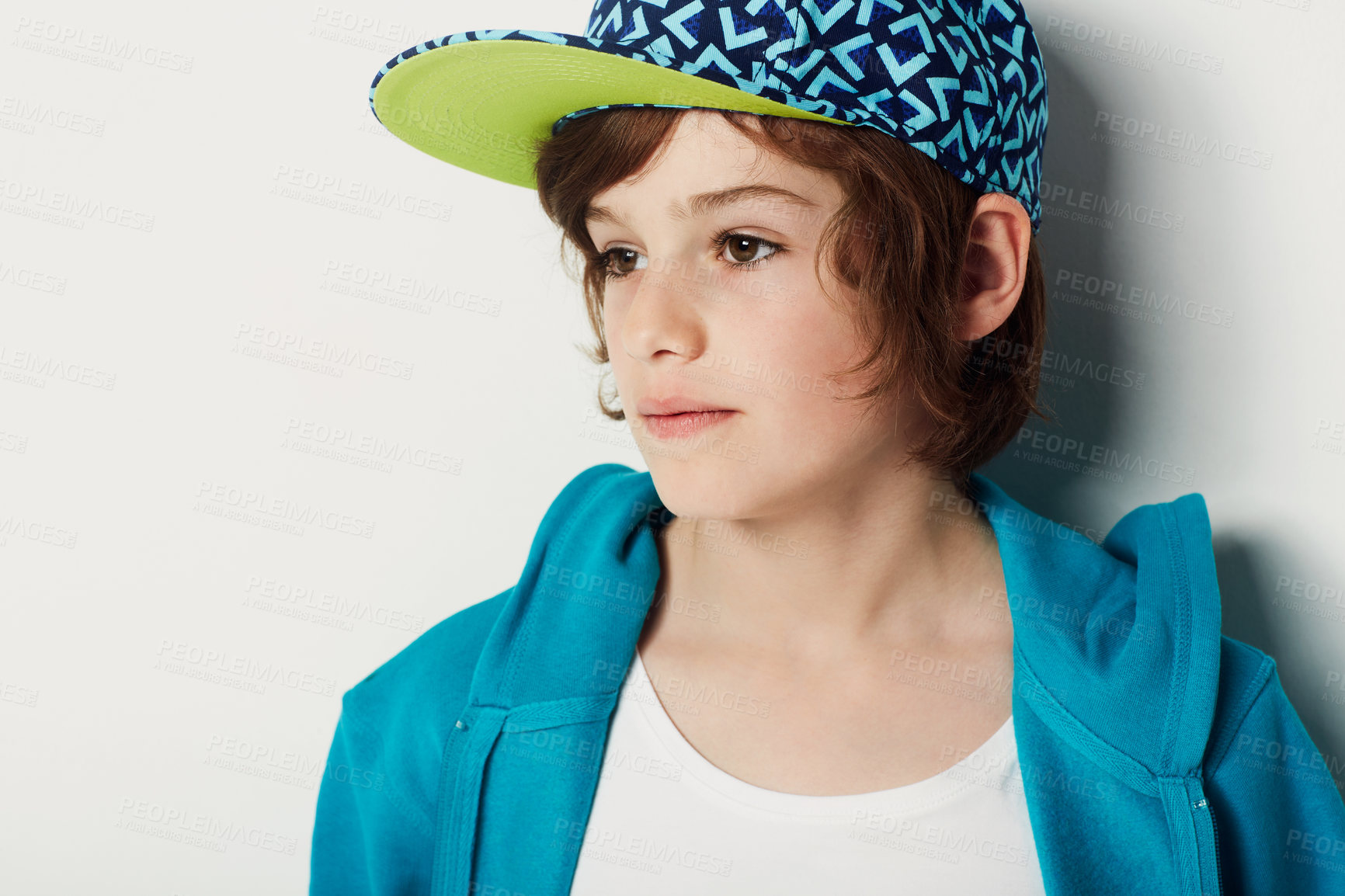 Buy stock photo Thinking, fashion and young child in a hoodie in studio isolated on a white background. Trendy style, cool kid and cap of boy or model in a hat, casual clothes and serious on a backdrop in Sweden