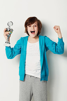 Buy stock photo Cute preteen boy holding a trophy while isolated on white