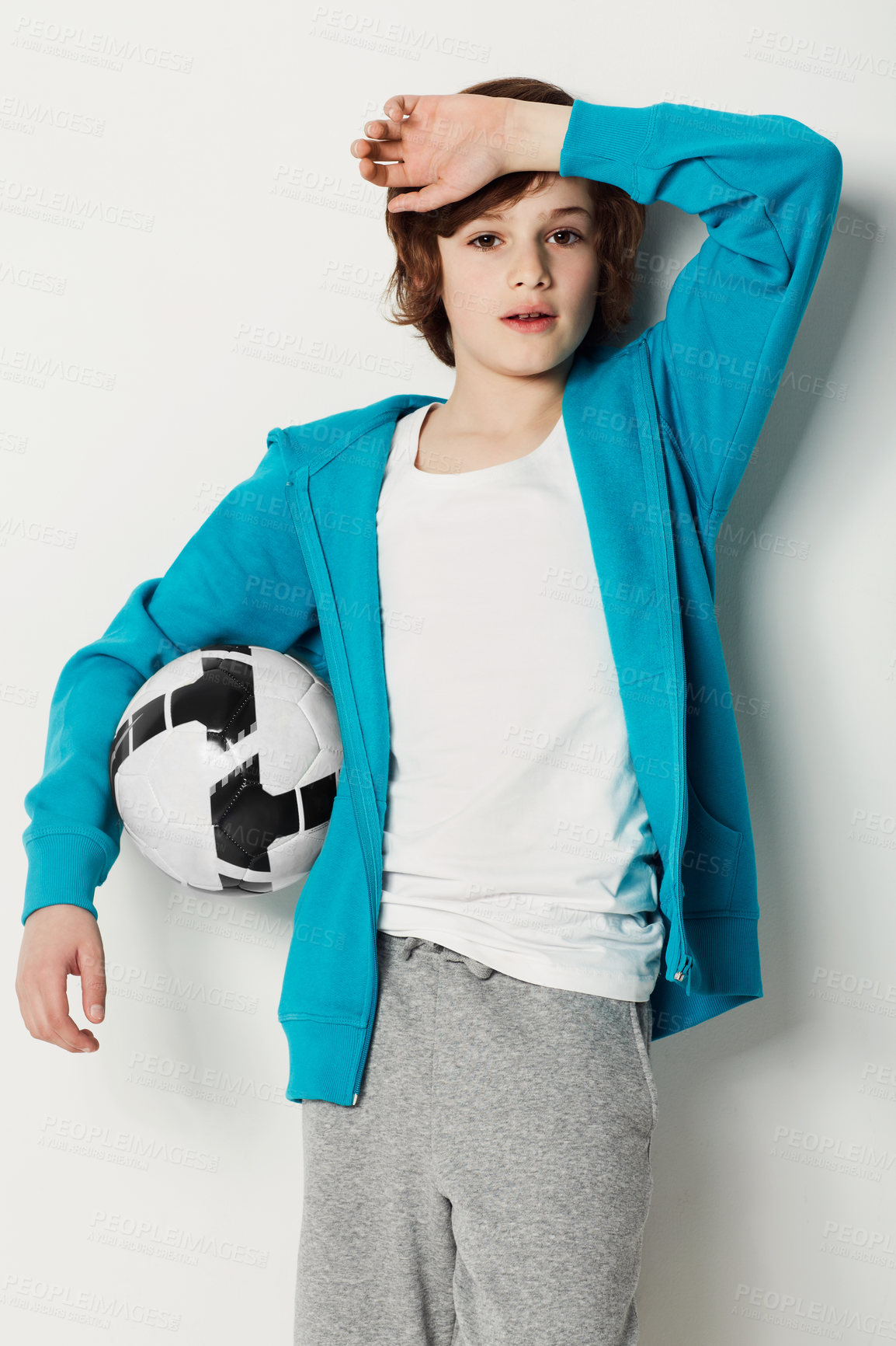 Buy stock photo Soccer, casual and portrait of teenager in a studio for sports training or exercise with style. Serious, fashion and boy kid athlete with football confidence and trendy outfit by white background.