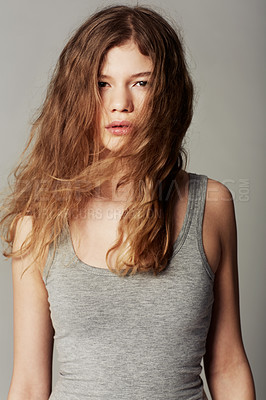 Buy stock photo Portrait of a pretty young teenage girl dressed casually against a gray background