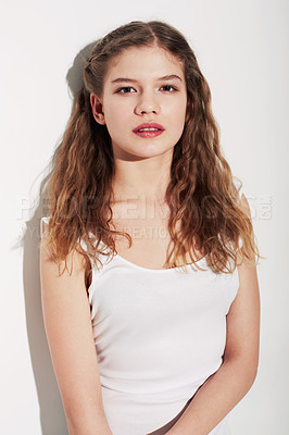 Buy stock photo Portrait of an attractive young teenage girl standing against a white background