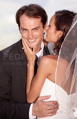 Buy stock photo Kiss, happy man and woman embrace at wedding with smile, love and commitment at outdoor reception. Romance, face of bride and groom at marriage celebration with blue sky, loyalty and future together.