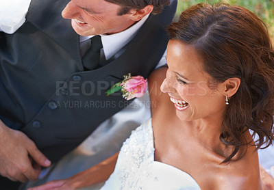 Buy stock photo Couple, laughing and love on wedding day in outdoors, together and excited for marriage and commitment. Happy people, romance and union or relaxing on grass, loyalty and humor and fun in partnership