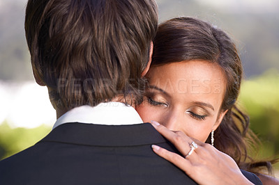 Buy stock photo Couple, union and embrace on wedding day for love, support and together for marriage and commitment. People, romance and hugging at outdoor ceremony, loyalty and ring for devotion and partnership