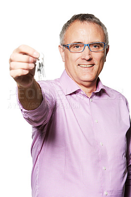 Buy stock photo Studio portrait of a mature man holding keys up to the camera