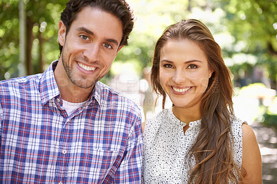 Buy stock photo Park, portrait and couple on a outdoor date with happiness and love together in nature. Sunshine, vacation and fun with a smile in summer on holiday feeling relax in the sun with blurred background