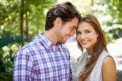 Buy stock photo Portrait, couple and hug in park with forehead, touch and bonding against a blurred background. Face, embrace and man with woman in nature, smile and excited for reunion, relationship or togetherness