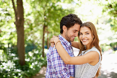 Buy stock photo Portrait, hug and couple in a park for date, valentines day and bonding while embracing against a blurred background. Face, love and man hugging woman in nature, excited or romantic outside in Mexico