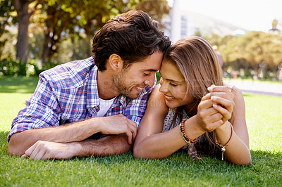 Buy stock photo Couple, love or forehead touch on grass date, nature park or garden bonding on valentines day, romance or anniversary trust. Smile, happy woman or man lying in relax environment or partnership picnic
