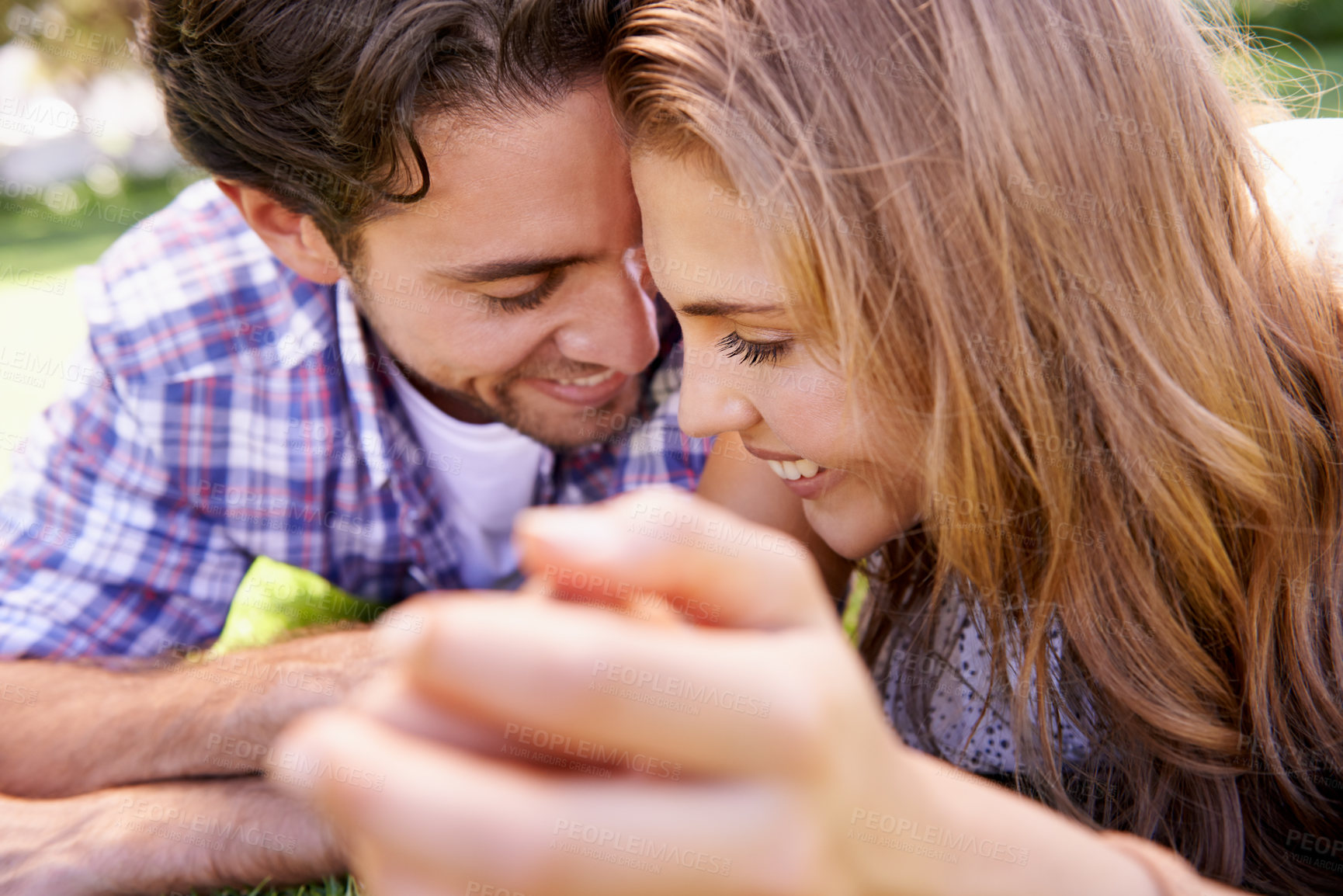 Buy stock photo Happy couple, bonding or love date on grass, nature park or garden on valentines day, romance or anniversary celebration. Smile, woman or man in relax environment, summer break or partnership picnic