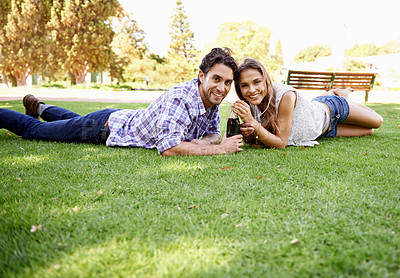 Buy stock photo Happy couple, park and valentines day date portrait with a drink on grass for love, bonding and time together. Smile of a young man and woman in nature for a summer picnic with a cola bottle outdoor