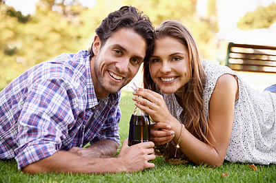 Buy stock photo Happy couple drink soda together in park, summer holiday or valentines date in a portrait for outdoor fun. Relax, love and young people or woman with partner sharing a cola bottle in garden picnic