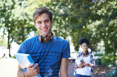 Buy stock photo College, student and portrait of happy man on campus to study on scholarship for education. University, academy and person with book, headphones and walking with smile in park at school after class