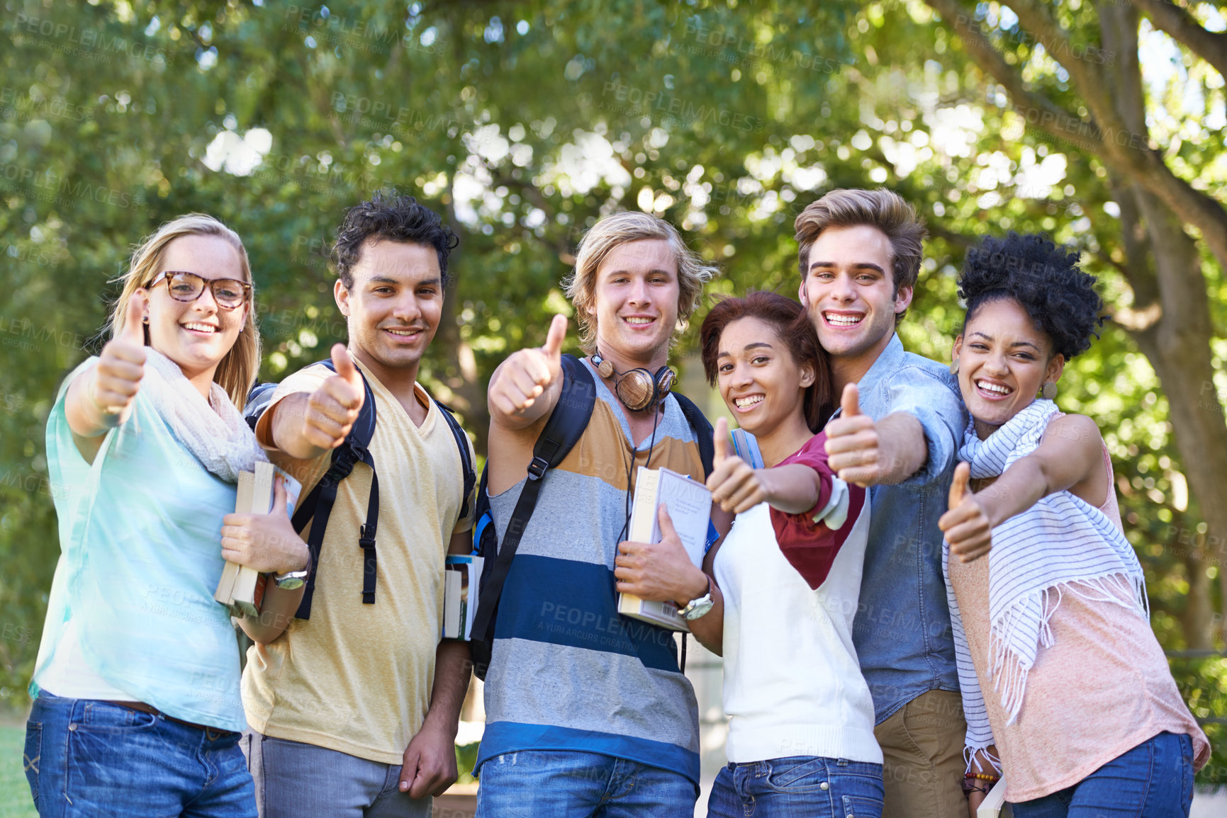 Buy stock photo Portrait of a group of students smiling for the camera with their thumbs up