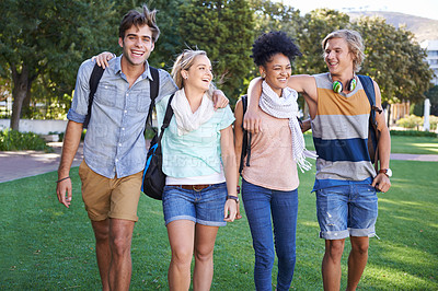 Buy stock photo A group of students taking a walking in a park after class