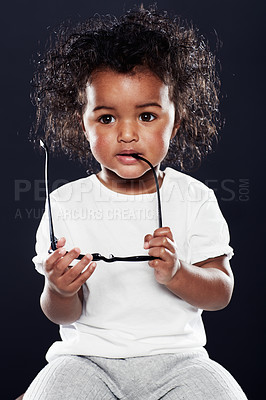 Buy stock photo Cropped shot of a cute girlholding spectacles on a black background