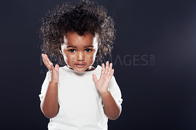 Buy stock photo Cute, kid and girl with expression, thinking and contemplation on a dark studio background. Mockup space, adorable toddler and child development with hands up and emoji with thoughts and wonder