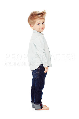 Buy stock photo Side view of a cute little boy standing against a white background - portrait