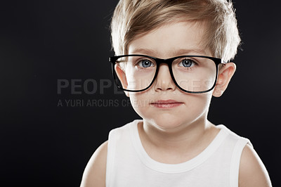Buy stock photo A young boy wearing glasses against a black background