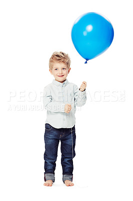 Buy stock photo A cute little boy smiling as he holds a blue balloon