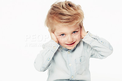 Buy stock photo Kid, happy and cover ears in portrait with shirt in studio background with cute face. Young child with smile hear loud noise while sensitive to sound in childhood as emoji on white, isolated backdrop