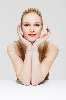 Buy stock photo Portrait, skincare and woman in makeup at table, red lipstick and cosmetics in studio isolated on a white background. Face, beauty model and hands in spa facial treatment, wellness or healthy glow