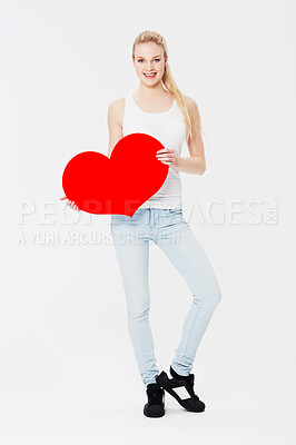 Buy stock photo Portrait, heart and valentines day with a woman in studio on a gray background for love, dating or romance. Red, date and romantic with a female holding an emoji, icon or symbol on blank space