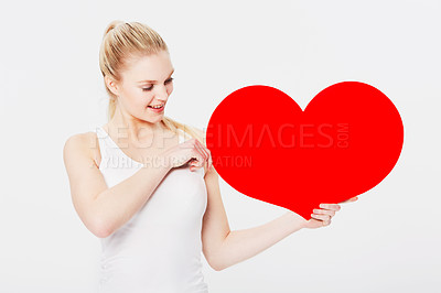 Buy stock photo Valentines day, happy and woman with a heart in a studio with a smile for a romantic gesture. Happiness, excited and female model from Australia holding a love shape isolated by a white background.