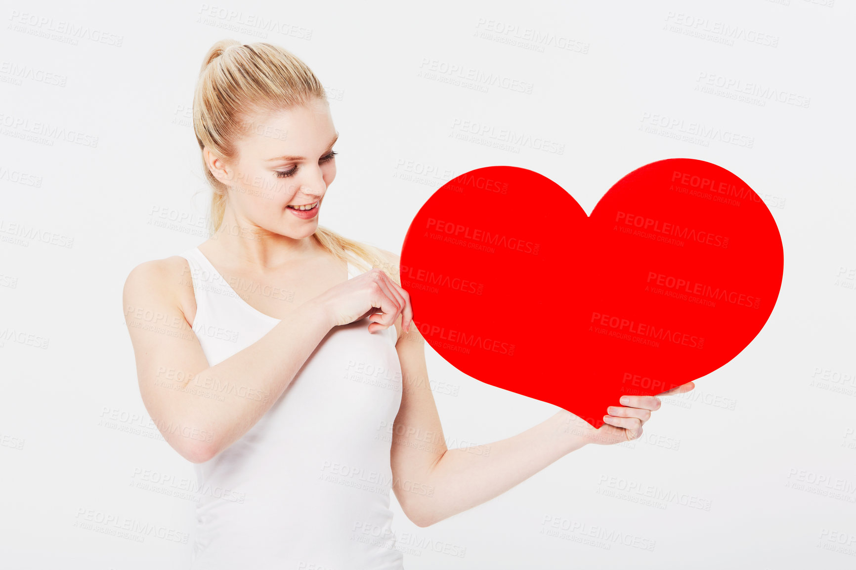 Buy stock photo Valentines day, happy and woman with a heart in a studio with a smile for a romantic gesture. Happiness, excited and female model from Australia holding a love shape isolated by a white background.