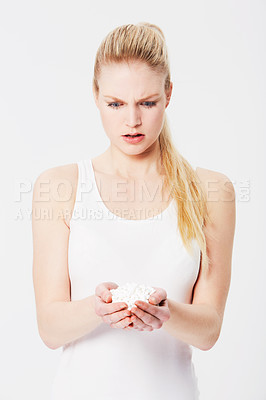 Buy stock photo Confused, shocked and woman holding pills in her hands or overdose isolated against a studio white background. Medicine, capsules and annoyed female with tablets due to mental health issues