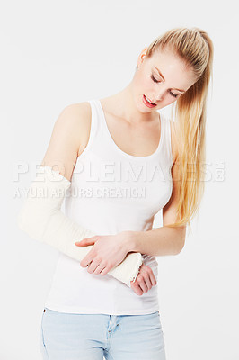 Buy stock photo Injury, pain and woman with a broken arm after an accident isolated on a white background. Hurt, handicap and girl holding an injured and bandaged limb for an emergency in a brace on a backdrop