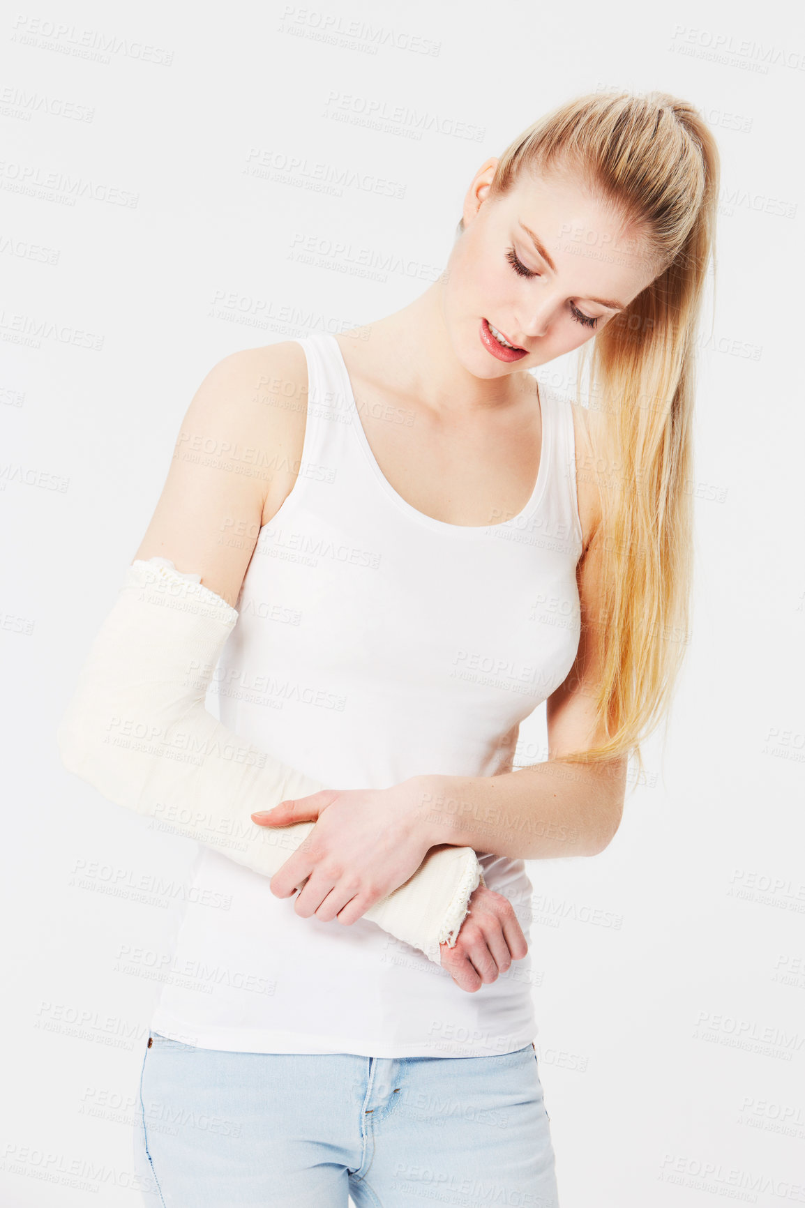 Buy stock photo Injury, pain and woman with a broken arm after an accident isolated on a white background. Hurt, handicap and girl holding an injured and bandaged limb for an emergency in a brace on a backdrop