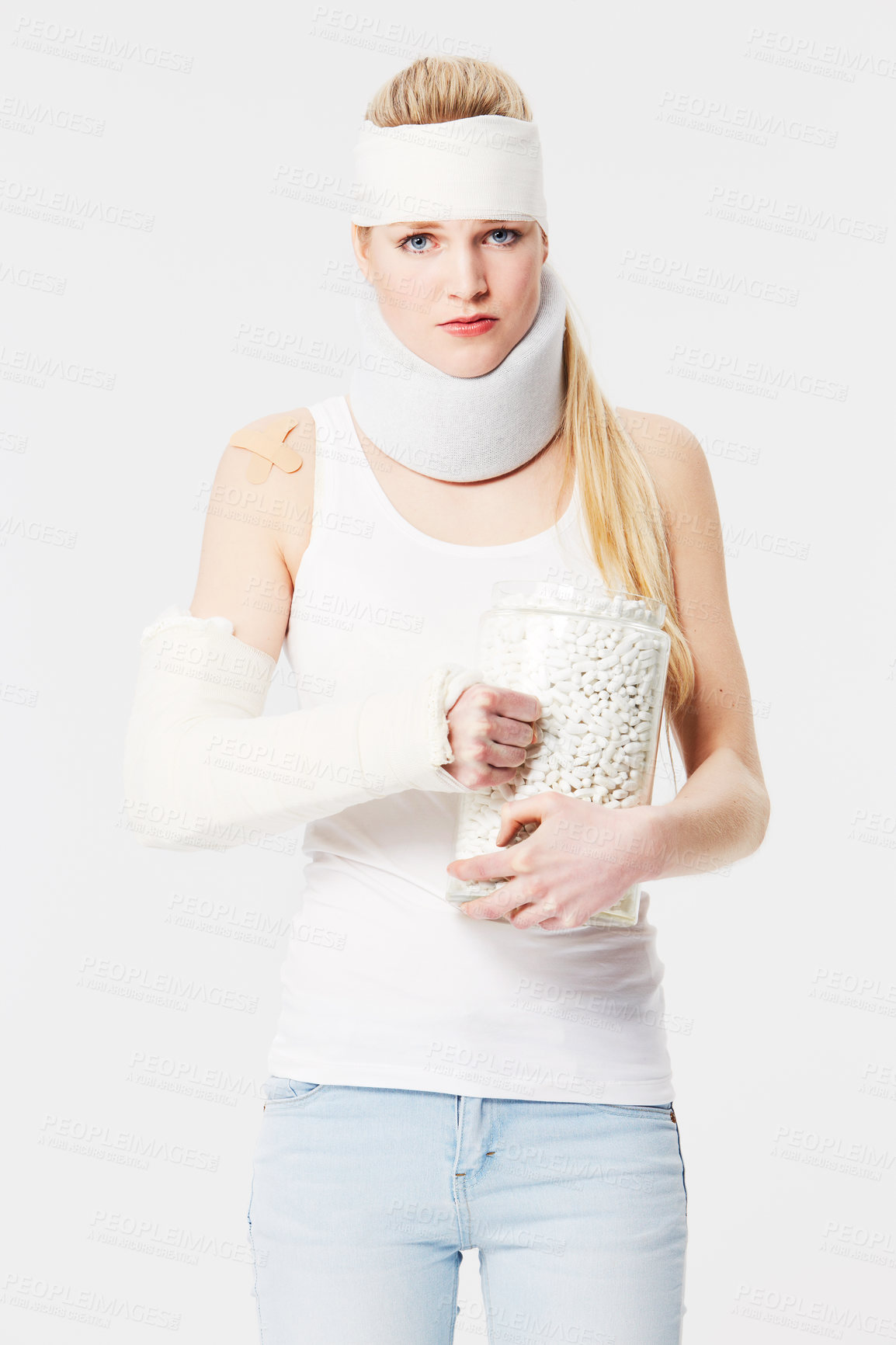 Buy stock photo Portrait, insurance and pills with an injured woman in studio on a gray background for medical aid. Healthcare, medical or injury with a young female patient in a brace and cast on blank space