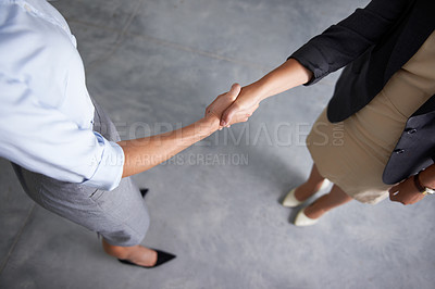 Buy stock photo Top view, handshake and business women in office for consulting deal, thank you or agreement. Closeup of employees shaking hands in collaboration, welcome and teamwork of b2b support, trust or hiring