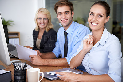 Buy stock photo Portrait of happy business people at desk in coworking space with career in market research office. Team leader, professional employees and project manager with smile on face at planning workshop.