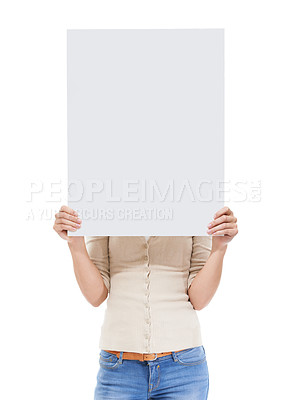 Buy stock photo Studio shot of a woman holding a blank sign in front of her face isolated on white