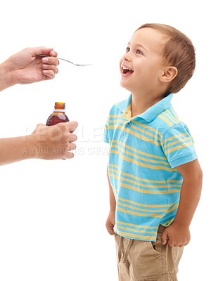 Buy stock photo Studio shot of a happy young boy being given some medicine on a spoon by his mother