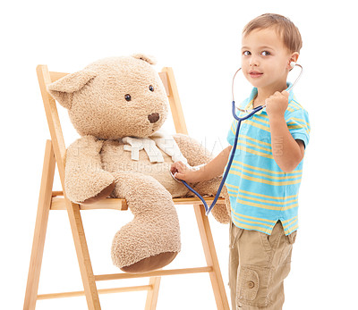 Buy stock photo Boy kid, teddy bear and stethoscope in studio for playing doctor, listening and wellness by white background. Child, healthcare game and development with plush toys, medical check or consultation