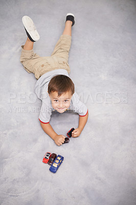 Buy stock photo Child, portrait and cars or toys play for learning growth or development, happiness or weekend. Kid, face and smile on home carpet with transportation vehicle for education game, creativity or fun