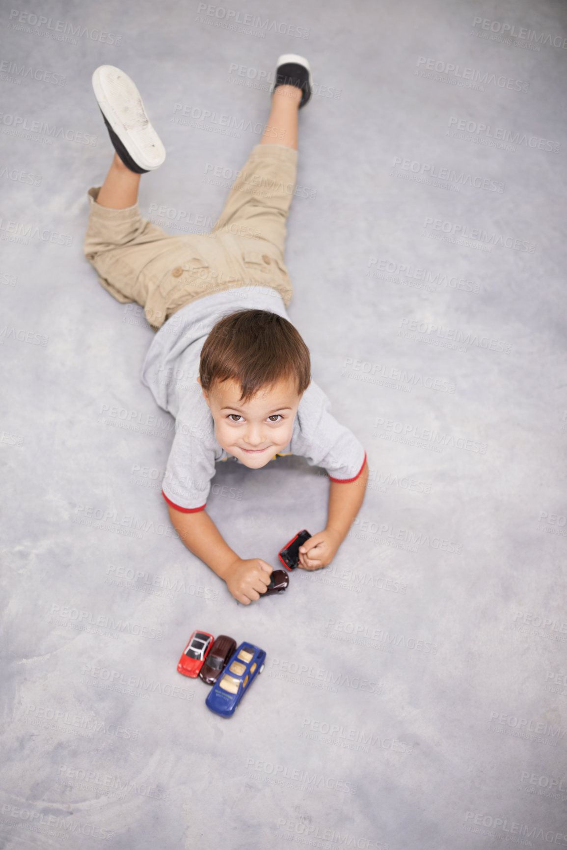 Buy stock photo Child, portrait and cars or toys play for learning growth or development, happiness or weekend. Kid, face and smile on home carpet with transportation vehicle for education game, creativity or fun