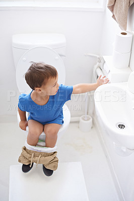 Buy stock photo Boy child, potty training and toilet paper with sitting, diaper and thinking for learning, development or progress. Kid, family home and back in bathroom with tissue, hygiene or solution with nappy