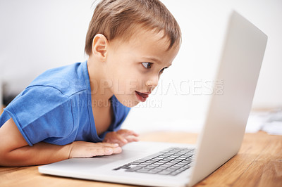 Buy stock photo Boy child, laptop and reading in home with search, movies and cartoon with learning video for development. Kid, computer and watch at desk in family house for education, studying and online course
