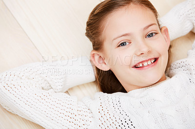 Buy stock photo Child, portrait and smile on floor for youth holiday or relax at home, cool outfit or vacation. Female person, face and happy kid for peaceful rest or casual style for confidence on weekend above