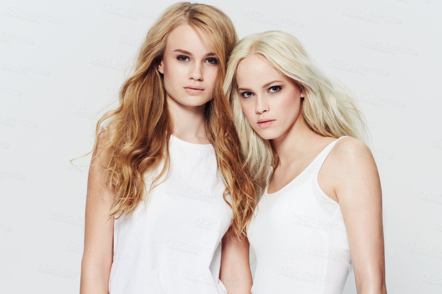 Buy stock photo Studio portrait of two young models against a white background