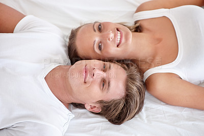 Buy stock photo Man, woman and portrait in bed for relax waking up from above for relationship care, romance or weekend. Happy partnership, face and smile in apartment for peaceful holiday or couple, love or rest